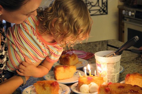 Lilly Bug blows out the candles on her homemade cake.
